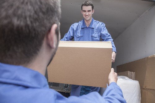 Man and a van service with boxes and moving equipment