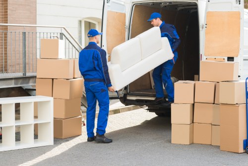 Boxes and furniture being loaded into a moving van