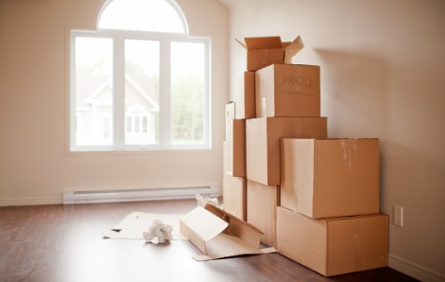 Urgent same day removals team working in Putney with moving boxes