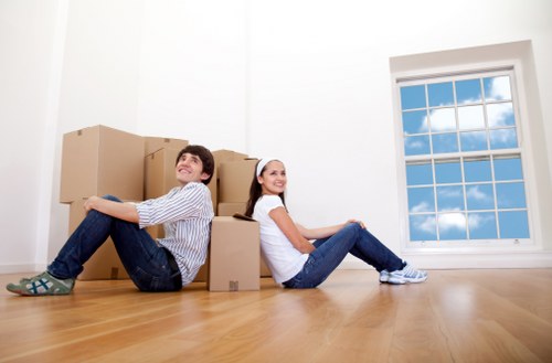 Furniture removals team handling a sofa in Putney