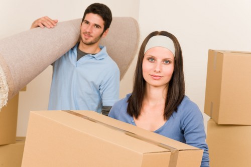 Removal team handling furniture and boxes for a Putney home relocation