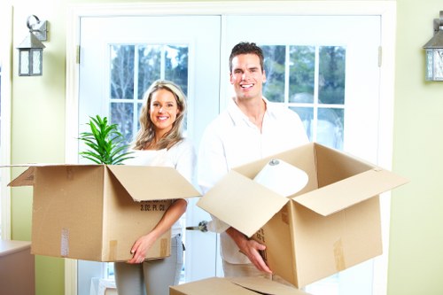 Commercial moving crew handling office equipment in southwest London